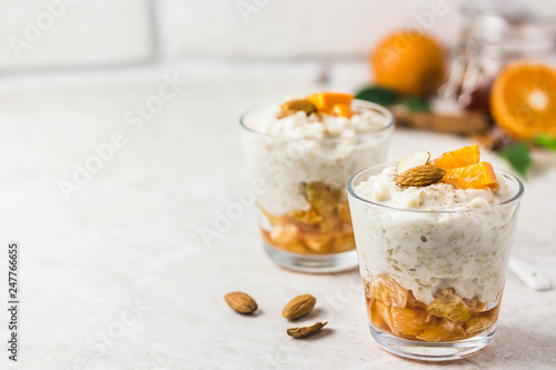 Overnight oats with tangerines and almonds. Selective focus, space for text.