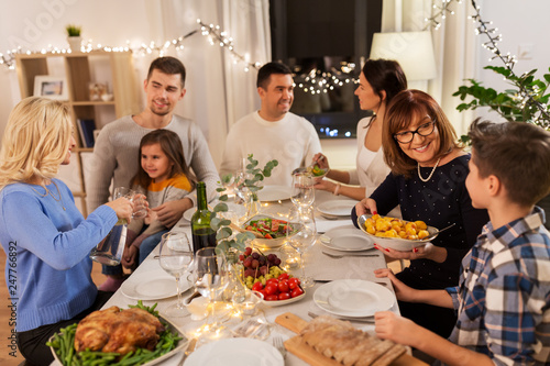 celebration  holidays and people concept - happy family having dinner party at home