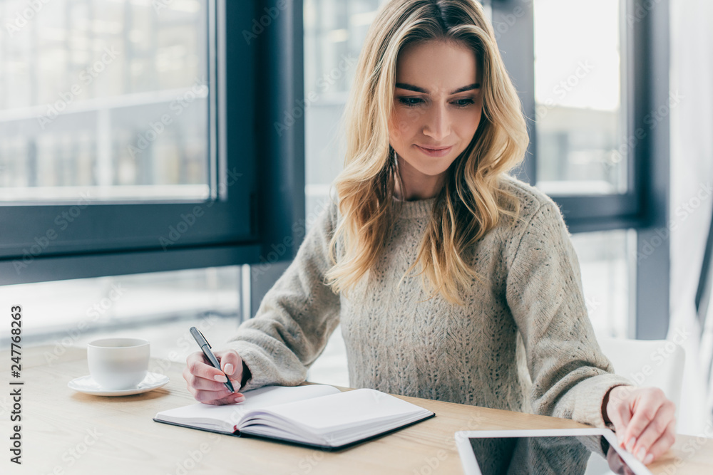 beautiful woman studying with digital tablet while holding pen near notebook beautiful woman studying with digital tablet while holding pen near notebook