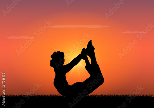 Silhouette of woman doing yoga at sunset