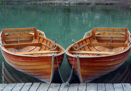 Rowboats parked in a row near a clear water lake © zatletic