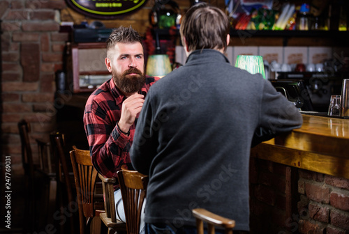 Friday relaxation in pub. Friends relaxing in pub. Friendly conversation with stranger. Hipster brutal bearded man spend leisure with friend bar counter in pub. Men relaxing in pub. Weekend leisure