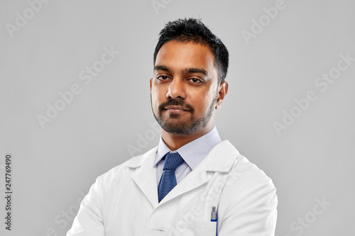 medicine, science and profession concept - indian male doctor or scientist in white coat over grey background