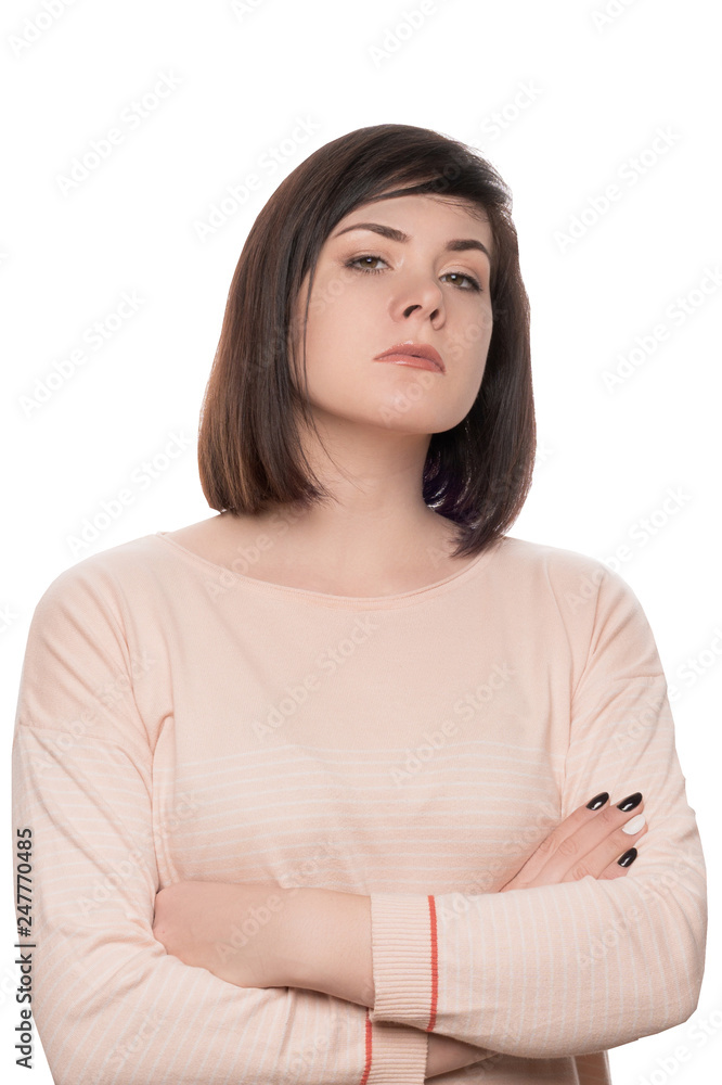 Feminist portrait. The girl looks arrogantly. Portrait of a strict brunette. Woman confident on white isolate background Feminist portrait. The girl looks arrogantly. Portrait of a strict brunette. Woman confident on white isolate background