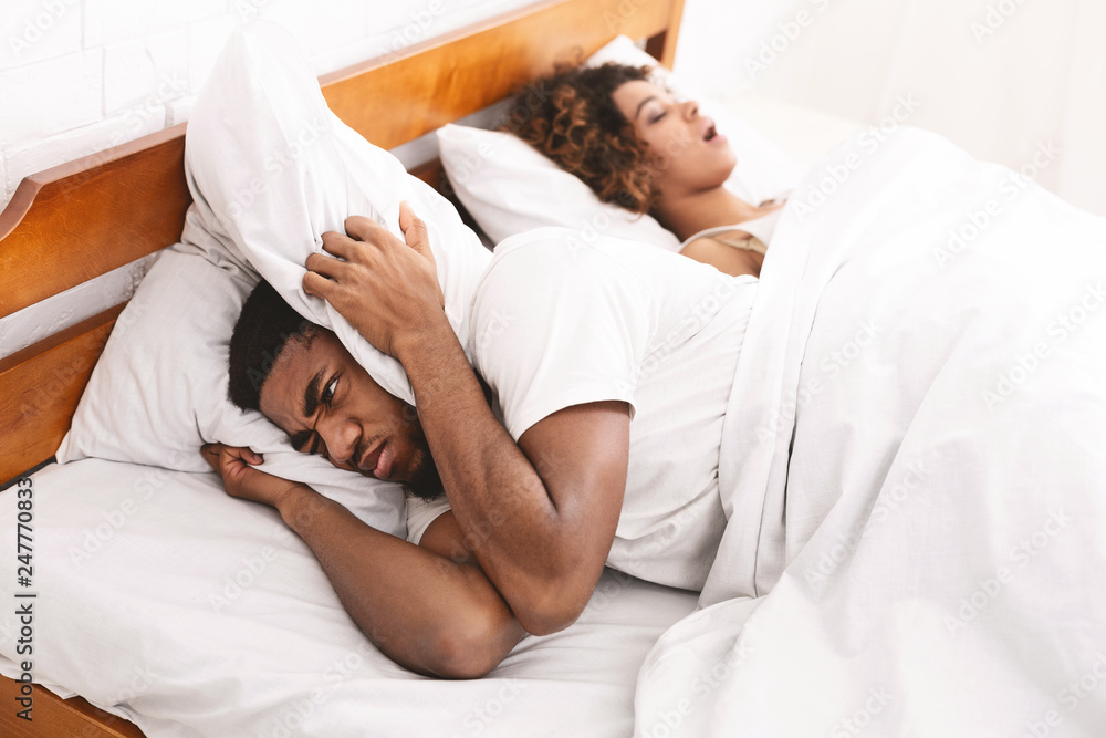 Tired and annoyed man of his girlfriend snoring Tired and annoyed man of his girlfriend snoring