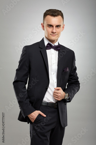 Young businessman on gray background