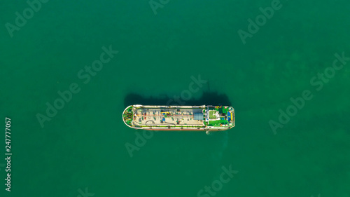 Oil tanker, gas tanker in the high sea.Refinery Industry cargo ship,aerial view,Thailand, in import export, LPG,oil refinery, Logistics and transportation with working crane bridge in harbor