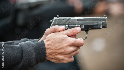 Left hand shooter shooting and holding gun. Close-up detail view