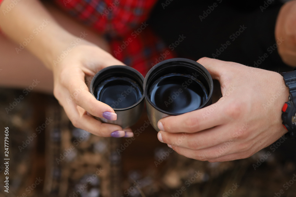 the girl and the guy drinking tea from a thermos the girl and the guy drinking tea from a thermos