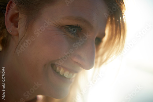 Portraits of a young lesbian couple enjoying their time together around a lake and jetty in winter sunshine