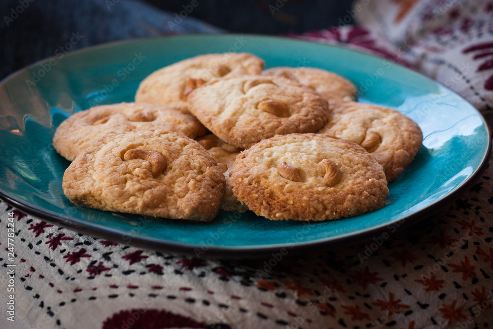 home-made cashew nut cookies, grandma's style on blue plate home-made cashew nut cookies, grandma's style on blue plate