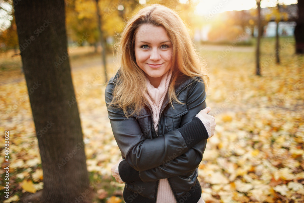 Beautiful girl walks and poses for photos in the autumn park with leaves Beautiful girl walks and poses for photos in the autumn park with leaves
