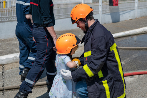 Fire uniformed father teaches his daughter Firefighter training photo