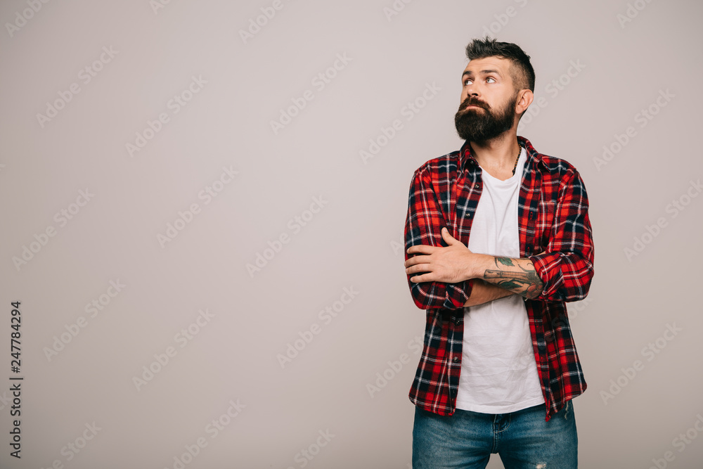 thoughtful bearded man in checkered shirt isolated on grey with copy space thoughtful bearded man in checkered shirt isolated on grey with copy space