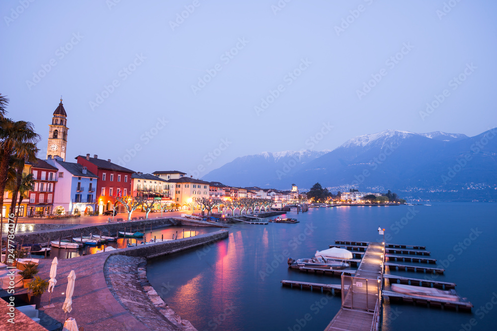 Ascona Village in Dusk with Alpine Lake Maggiore and Mountain in Ticino, switzerland.
