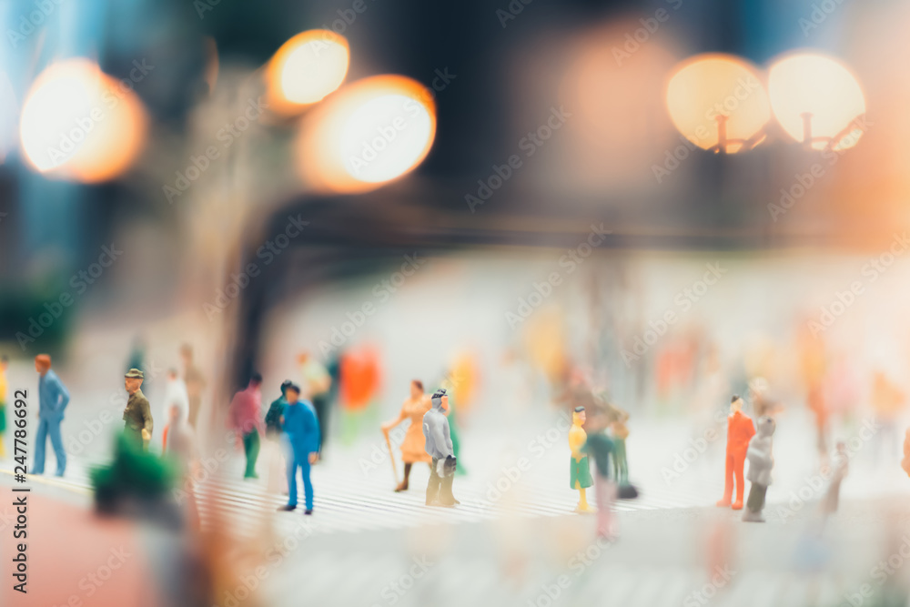 miniature people walking on streets,people are moving across the pedestrian crosswalk in the city road