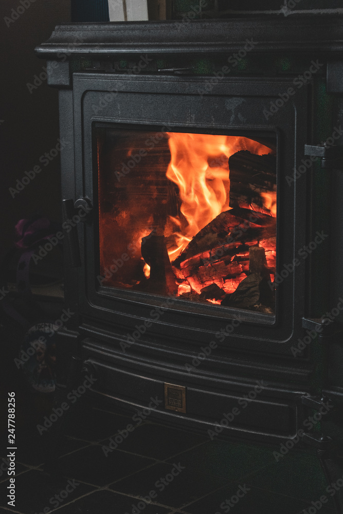 Cozy warm fireplace wooden stove close up interior burning fire