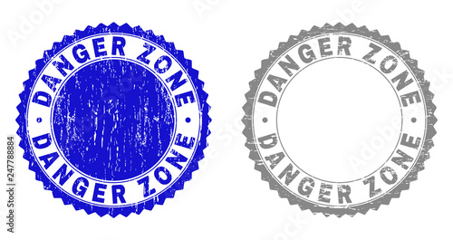 Grunge DANGER ZONE watermarks isolated on a white background. Rosette seals with grunge texture in blue and gray colors. Vector rubber stamp imprint of DANGER ZONE title inside round rosette.