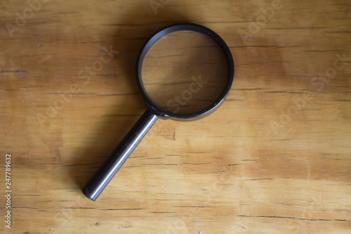 Magnifying glass on Wood plank wall texture background
