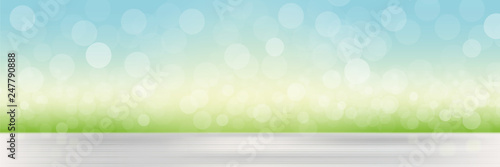 Abstract vector spring or summer defocused banner with dots of light. Natural background with blurred grass and sky and bokeh effect, mockup for advertising organic cosmetics or natural products, food
