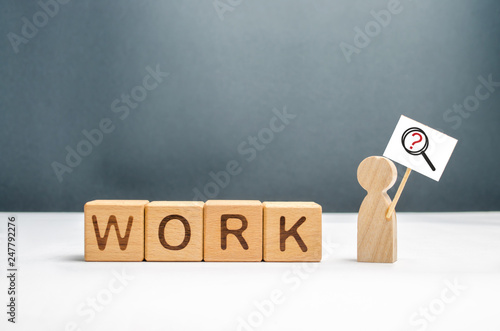 Obraz na plátně Man with a poster and a magnifying glass near the cubes with the word work