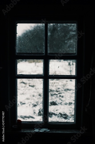 Worn window with a winter view. Old window in europe
