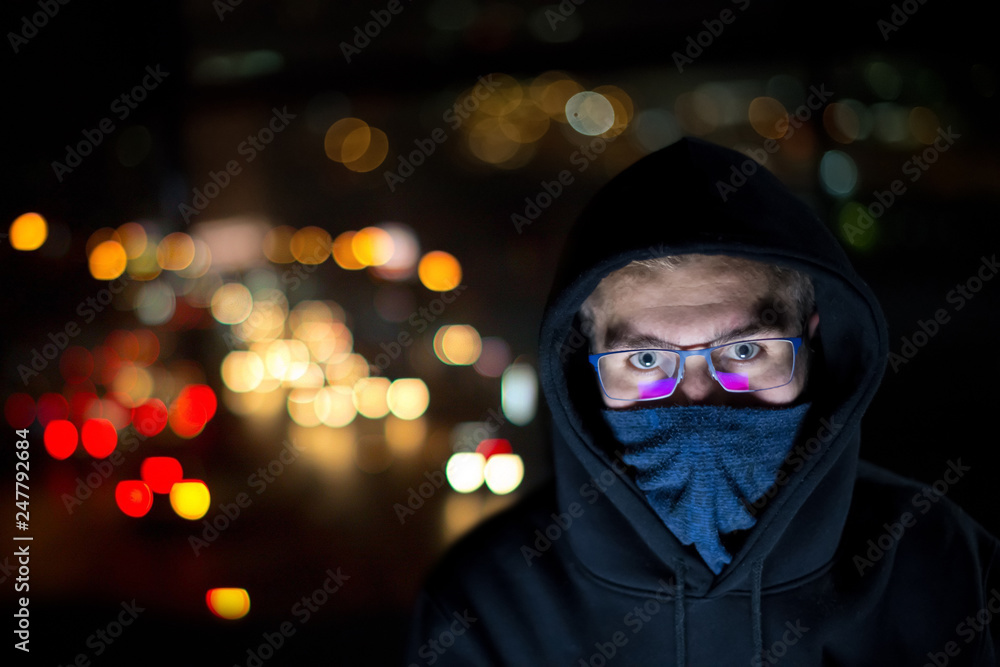 hacker using laptop computer while working in dark office hacker using laptop computer while working in dark office