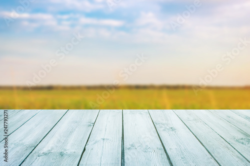 blue table on blurred background of landscape with blue sky - can use for display or montage your product.Template mock up for display of product