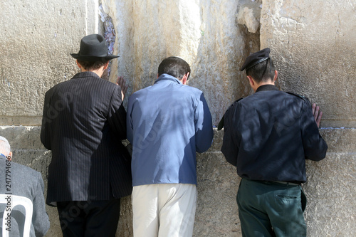Jewish men pray at the western wall in Jerusalem, IL