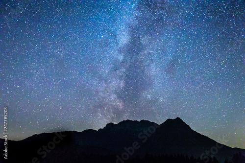 dark sky with milky way galaxy above the alps in the tyrol region of austria in europe during summer