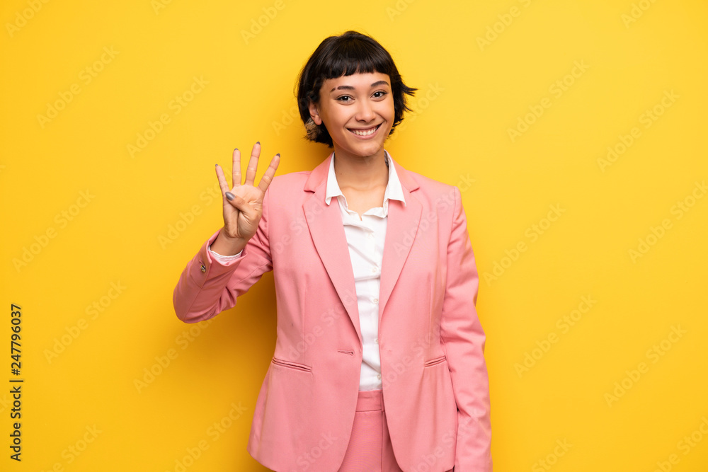 Modern woman with pink business suit happy and counting four with fingers Modern woman with pink business suit happy and counting four with fingers