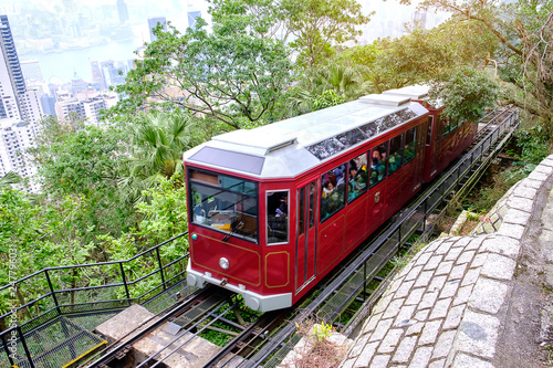 Victoria Peak Tram and unidentified people with Hong Kong city skyline background. landmark and destination for tourist attractions in HK