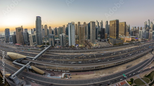Canvas Print Dubai marina with traffic on sheikh zayed road panorama day to night timelapse lights turn on