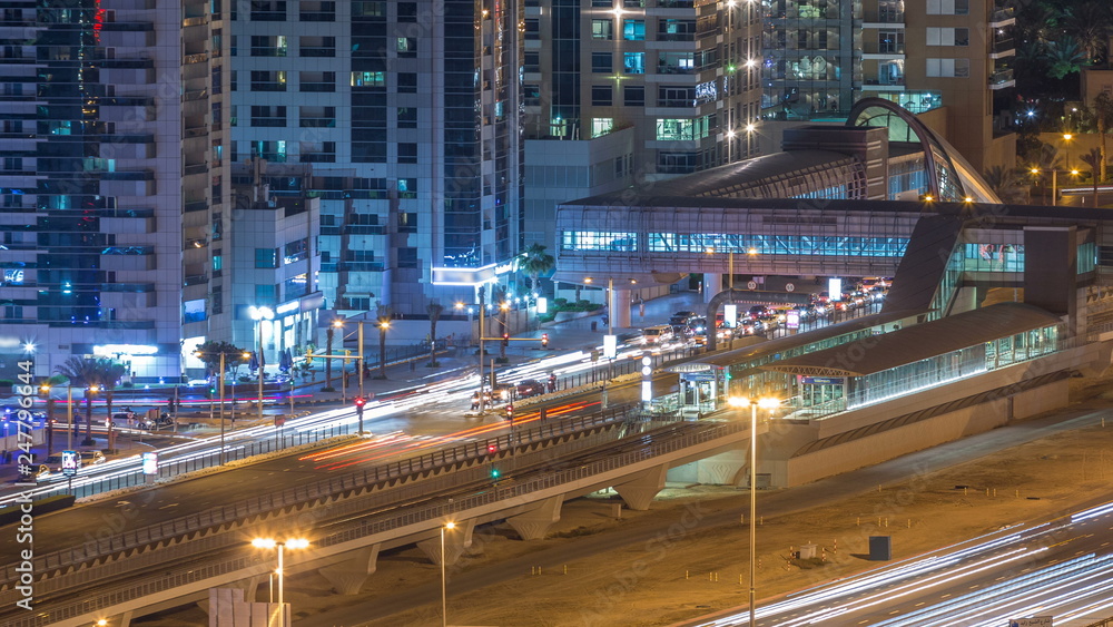 Aerial view of Dubai Tram in Dubai marina night timelapse.