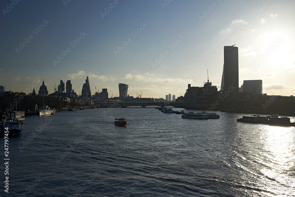 Fototapeta premium Residents and tourists exploring the city centre of London in early morning spring sunlight