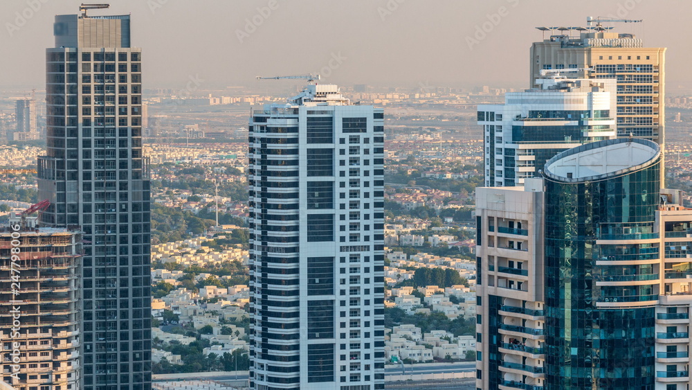 Fototapeta premium Dubai marina and JLT skyscrapers aerial skyline during sunset timelapse.