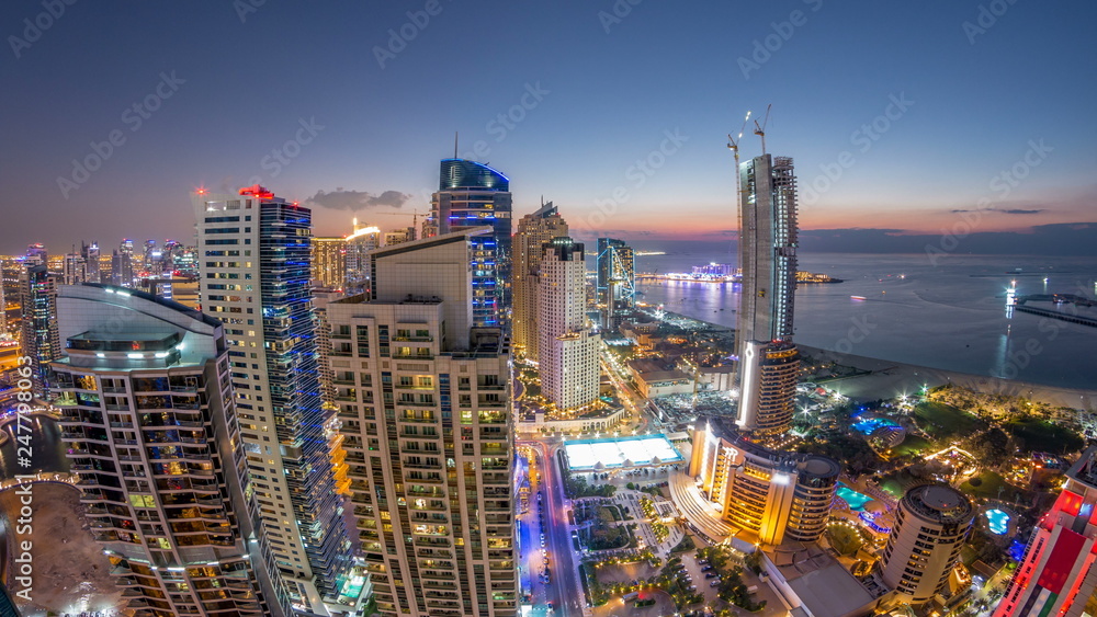 Obraz premium JBR and Dubai marina after sunset aerial day to night timelapse