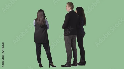 The agent in office clothes is standing near young couple, discussing. Back view.. Alpha channel background