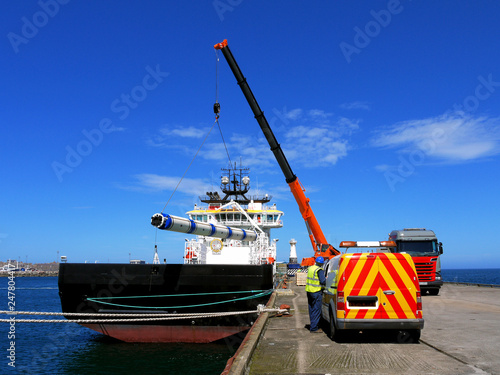 Offshore oil industry supply vessel loading cargo. photo