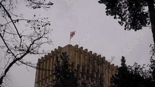 Flag of Georgia on the roof of a tall building photo