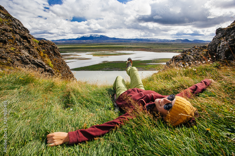 Happy young woman in bright clothes traveling Iceland, enjouing nature - obrazy, fototapety, plakaty 