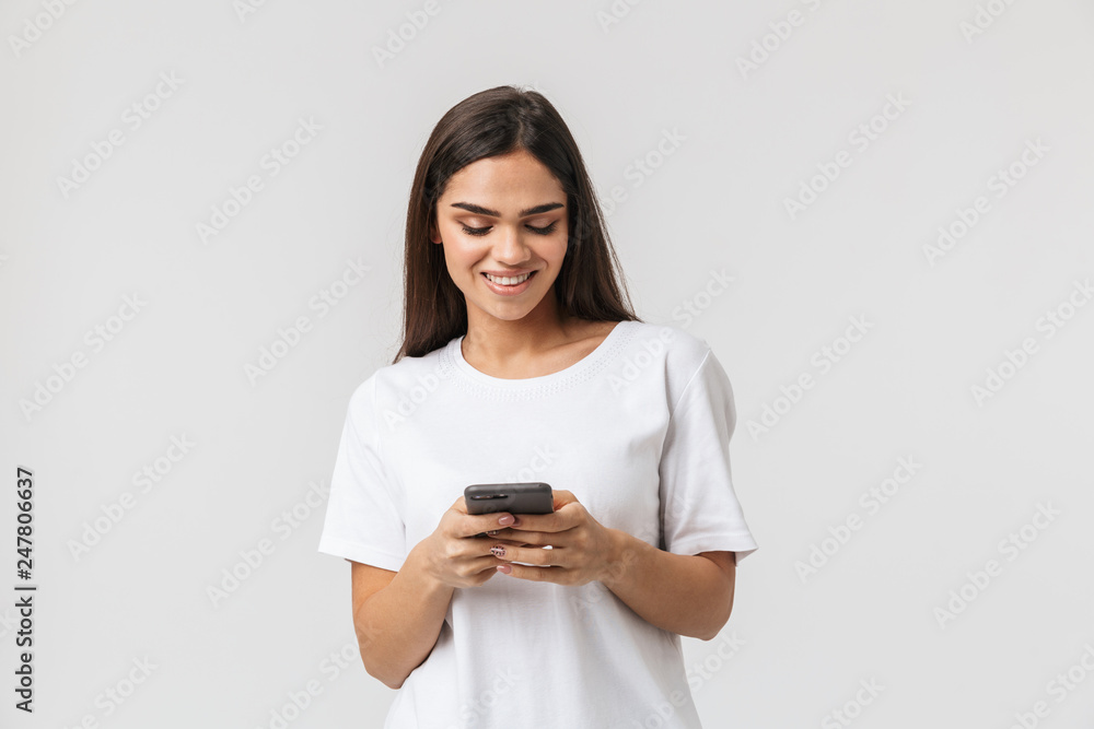 Smiling young woman casualy dressed standing Smiling young woman casualy dressed standing