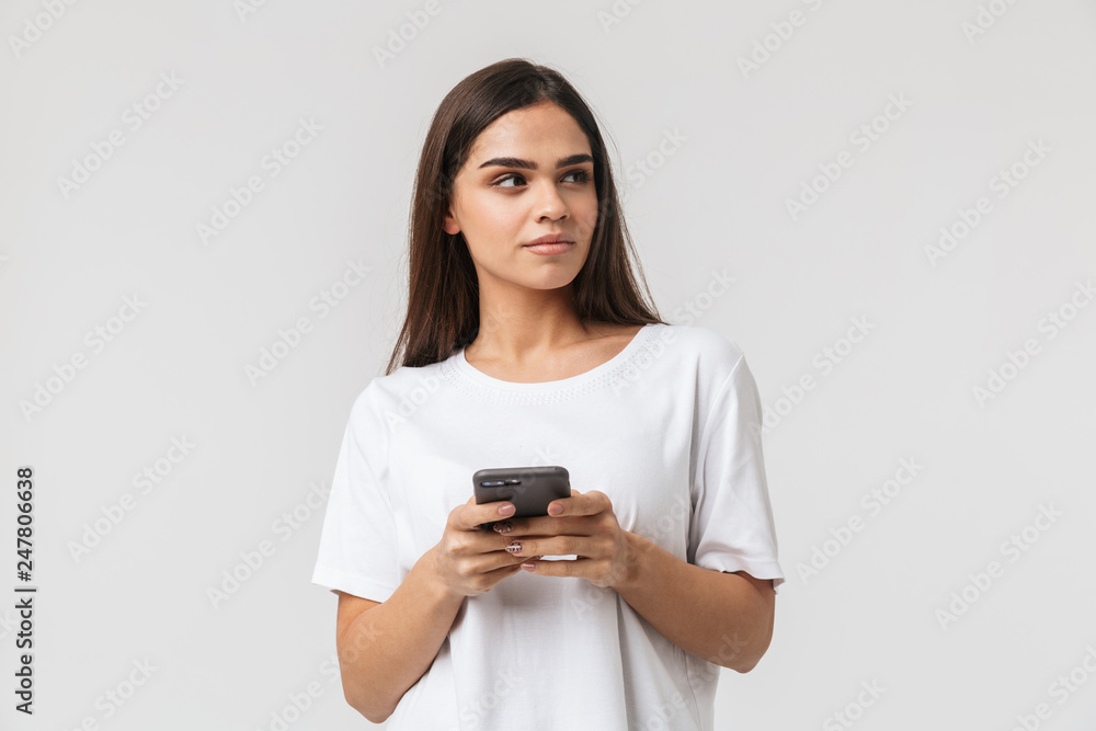 Smiling young woman casualy dressed standing Smiling young woman casualy dressed standing