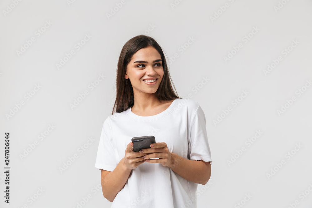 Smiling young woman casualy dressed standing Smiling young woman casualy dressed standing