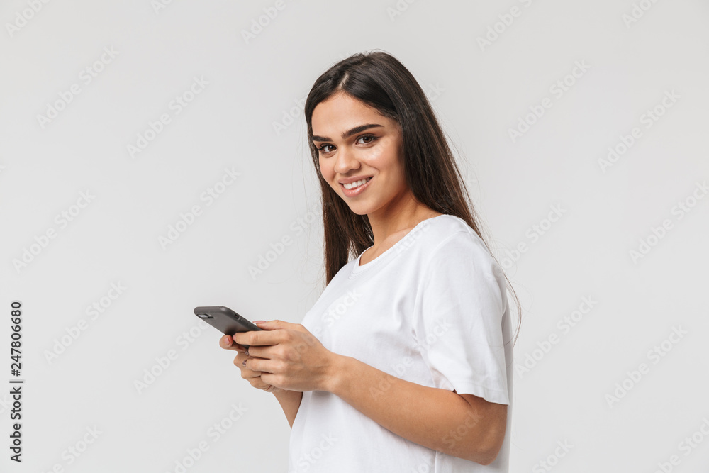 Smiling young woman casualy dressed standing Smiling young woman casualy dressed standing