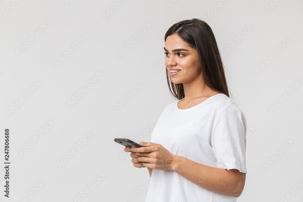 Smiling young woman casualy dressed standing Smiling young woman casualy dressed standing