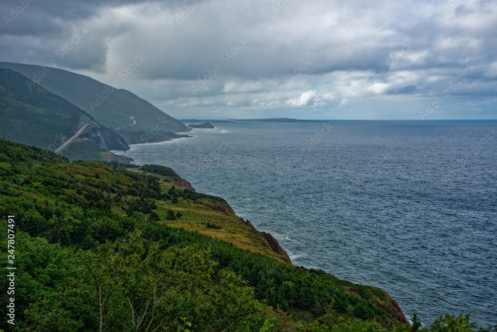 The coast of Nova Scotia in the rain with the Cabot Trail in the distance