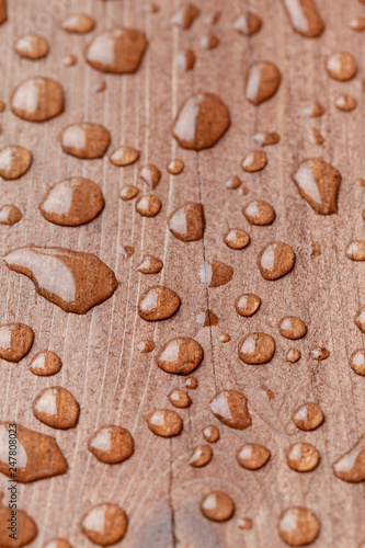 Water drops on a brown wooden surface