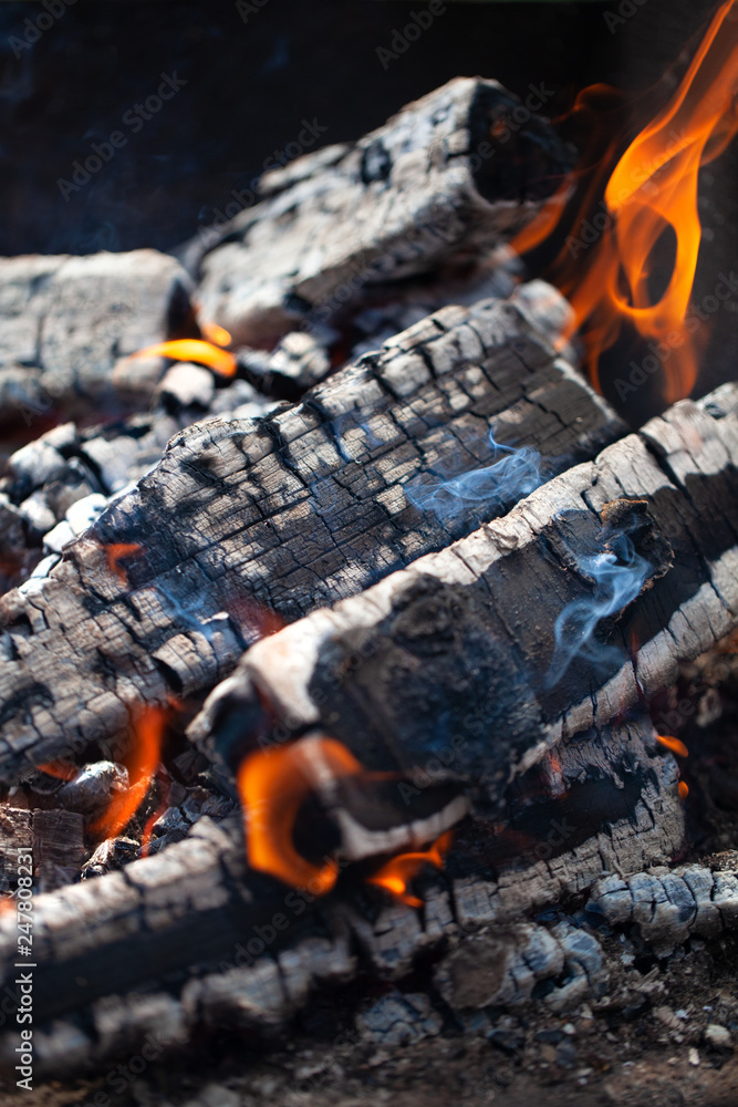 Burning firewood. Selective focus. Shallow depth of field Burning firewood. Selective focus. Shallow depth of field