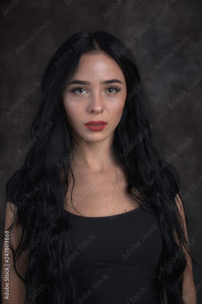 Young beautiful girl on a dark background